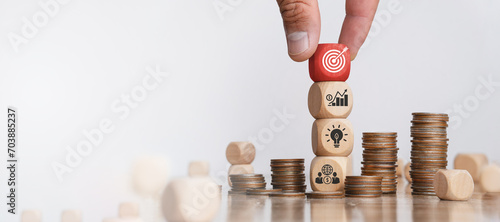 Business strategy concepts and action plans are planned by targeting marketing, goals, success and business development. Hand holding wooden blocks with arrangement icons photo
