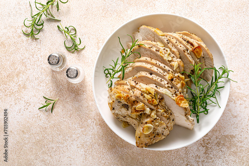 Turkey meat fillet baked with garlic, rosemary and spices. Top view