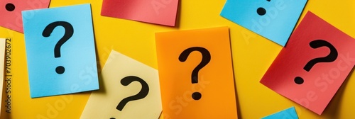 Colorful post-it notes with question marks on a vivid yellow background, decision-making concept