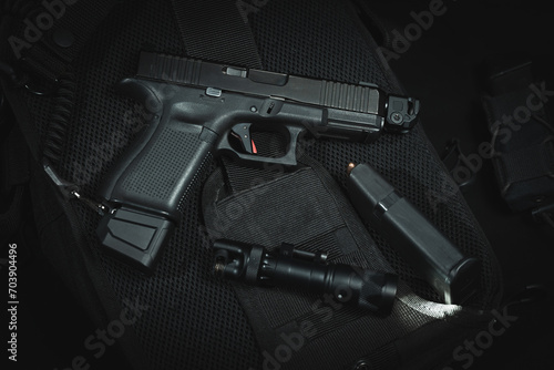 Tactical pistol g19 with muzzle compensator and extended magazine and weapon flashlight.