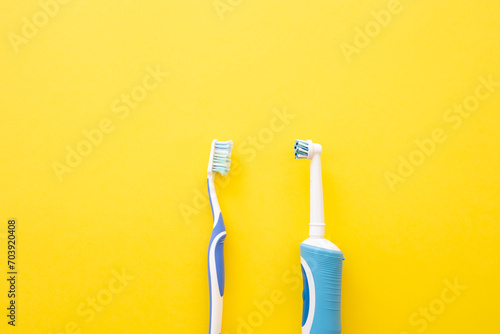 Electric toothbrush on a yellow background. Old and new dental account photo