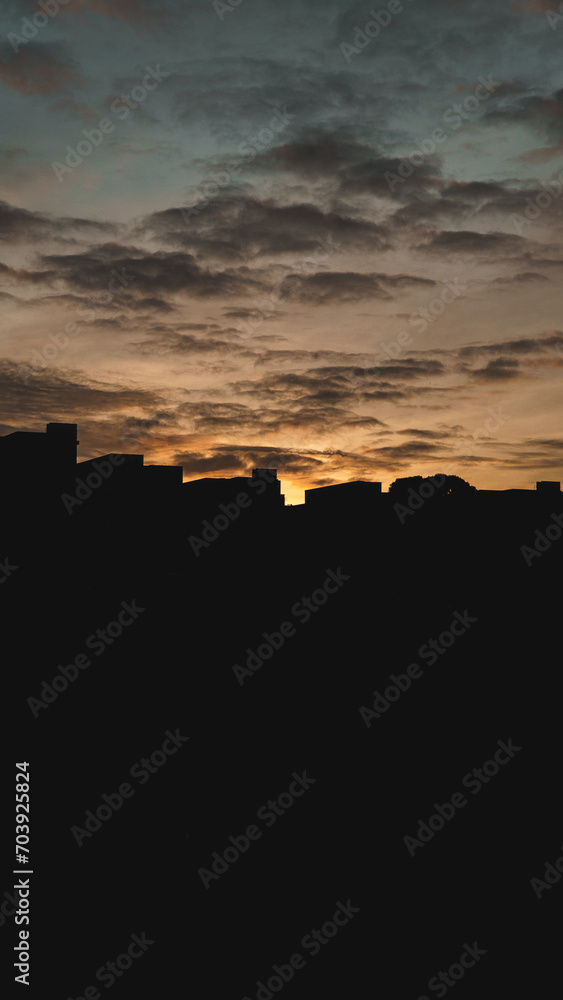 Sunrise by the city skyline