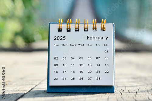 February 2025 white calendar with green blurred background. New year concept.