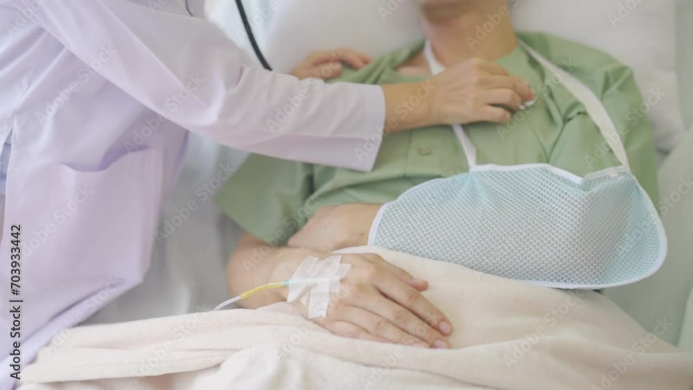 Doctor stand beside of patient bed then use stethoscope to check symptom of patient who lie on bed. Doctor stand beside of patient bed then use stethoscope to check symptom of patient who lie on bed.