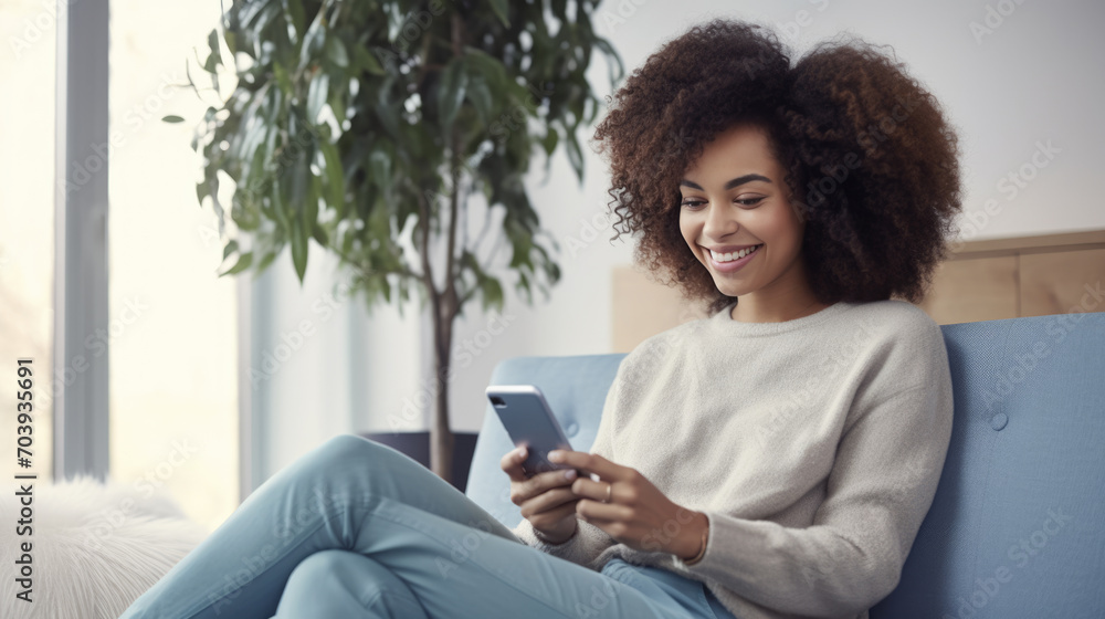 Happy woman using a smartphone while comfortably seated on a couch Happy woman using a smartphone while comfortably seated on a couch