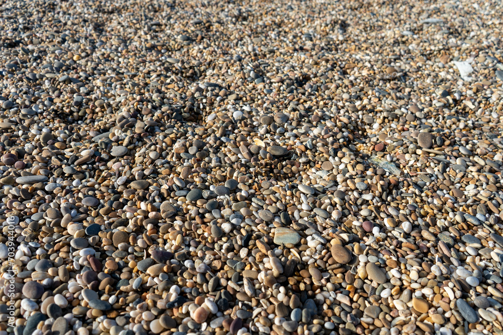 Background of colorful and rounded stones illuminated by the sun. Background of colorful and rounded stones illuminated by the sun.