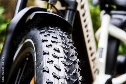 4-Inch Thick Tires with Powerful Tread on the Front Wheel of a Fat Bike, Shallow Depth of Field