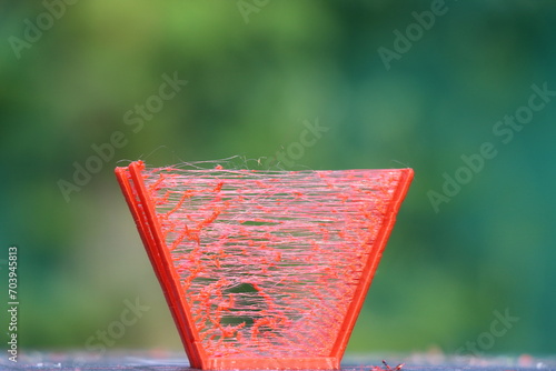 3D printed model with an issue that is called stringing which looks like a thin thread bridging between two parts