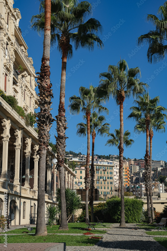 Romantic backstreet, side street or alley in historic old town of Genoa, Italy with historic Mediterranean style architecture facades, a landmark sightseeing tourist spot in downtown	