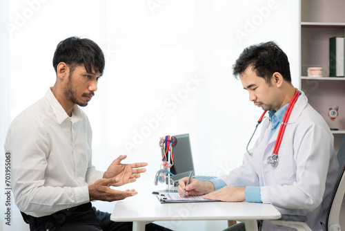 Doctor counseling of male patient with suspected bacterial prostatitis Prostate disease and treatment Anatomical model of the male reproductive system in the hands of a doctor.