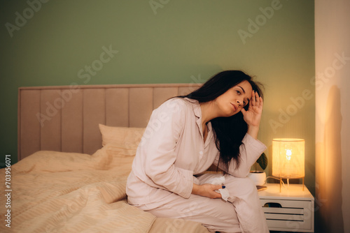 Image of sick woman lying in bed