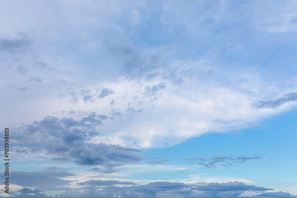 High evening sky with dark and light puffy clouds at sunset High evening sky with dark and light puffy clouds at sunset