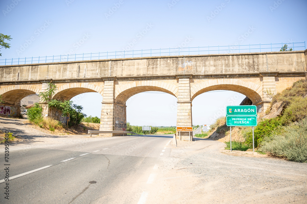 Canal de Aragón y Cataluña - Canal of Aragon and Catalonia aqueduct over the A-140 paved road at the border between Catalonia and Aragon, Spain