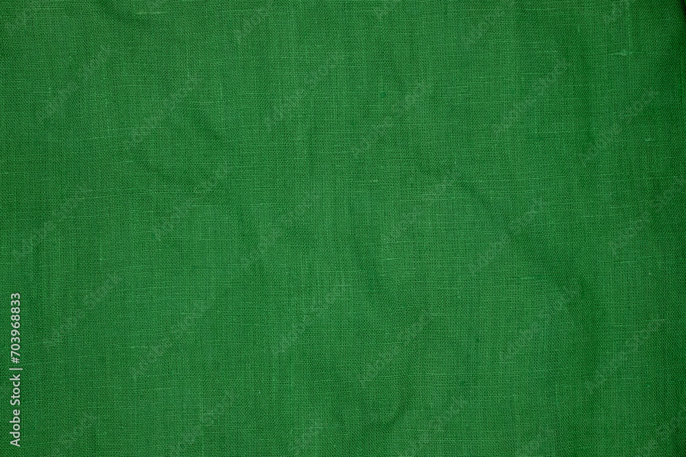 Fototapeta premium Green linen fabric texture. Sustainable and environmentally friendly textile. Copy space.
