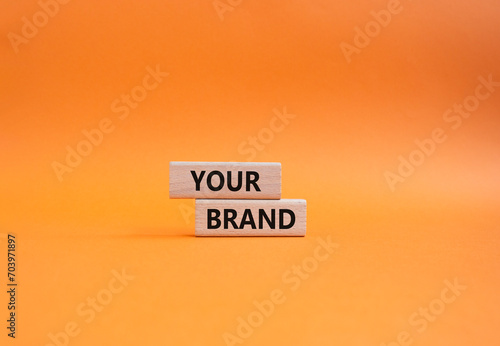 Your Brand symbol. Concept word Your Brand on wooden blocks. Beautiful orange background. Business and Your Brand concept. Copy space