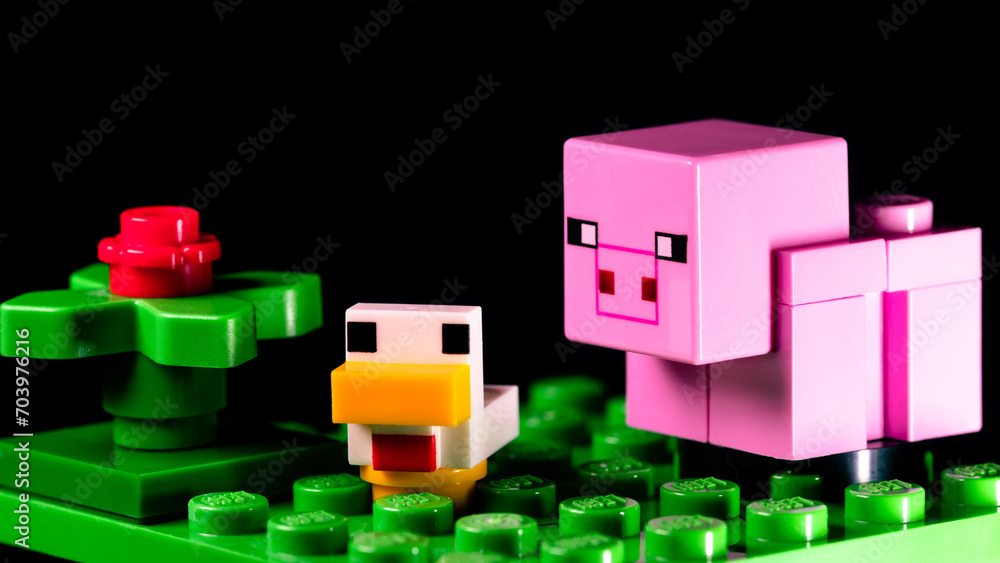 Obraz premium LEGO Minecraft pig and duck on a green meadow next to a red flower