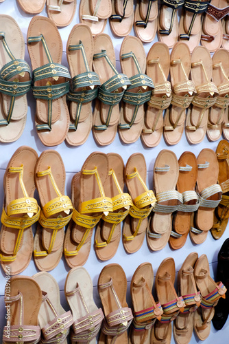 Colorful Handmade chappals (sandals) being sold in an Indian market, Handmade leather slippers, Traditional footwear.