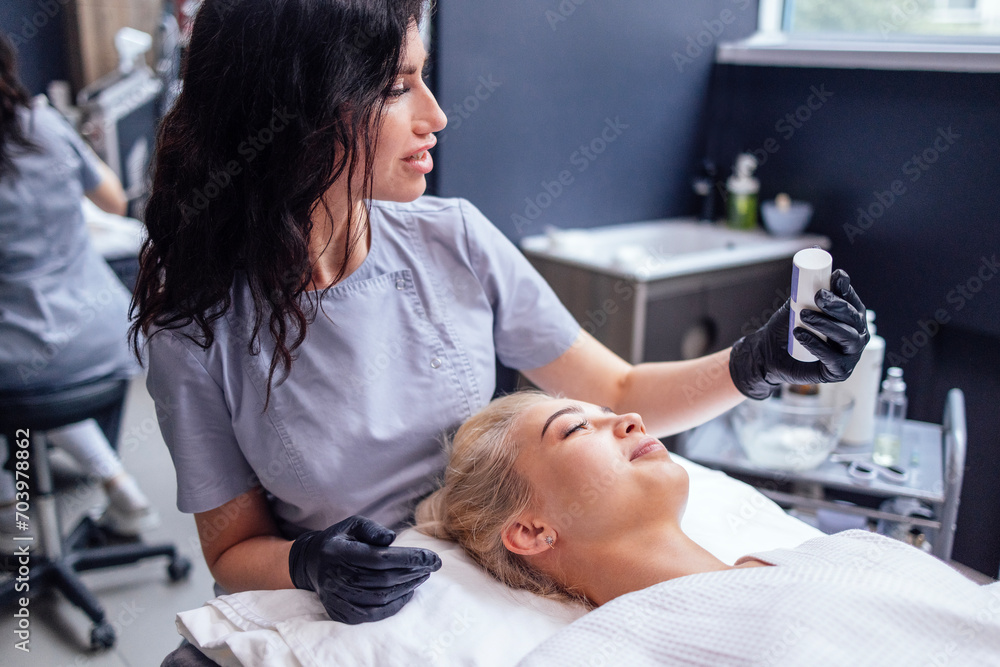 Pretty caucasian beautician communicates with her female client.