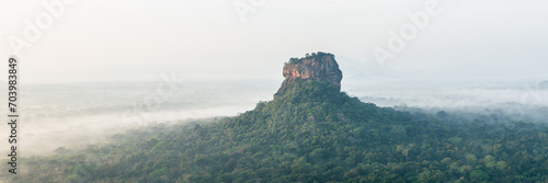 View of Sigiriya Rock from Pidurangala Rock at Sunrise on a Foggy Morning 