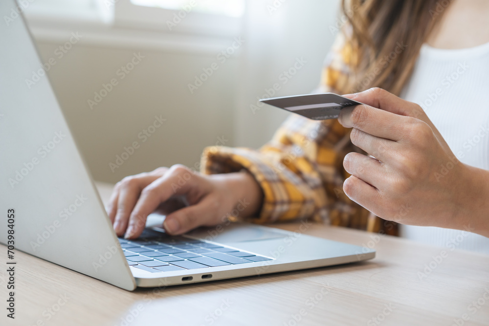 Internet banking, Online shopping at home, asian young woman hand in typing on keyboard, holding credit card, using laptop computer, spending money with purchase on store at home. Shopaholic ecommerce - obrazy, fototapety, plakaty 