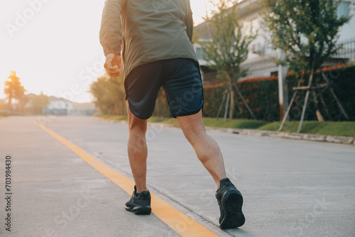 Athlete runner feet running on road, Jogging concept at outdoors. Man running for exercise..Athlete runner feet running on road, Jogging concept at outdoors. Man running for exercise.