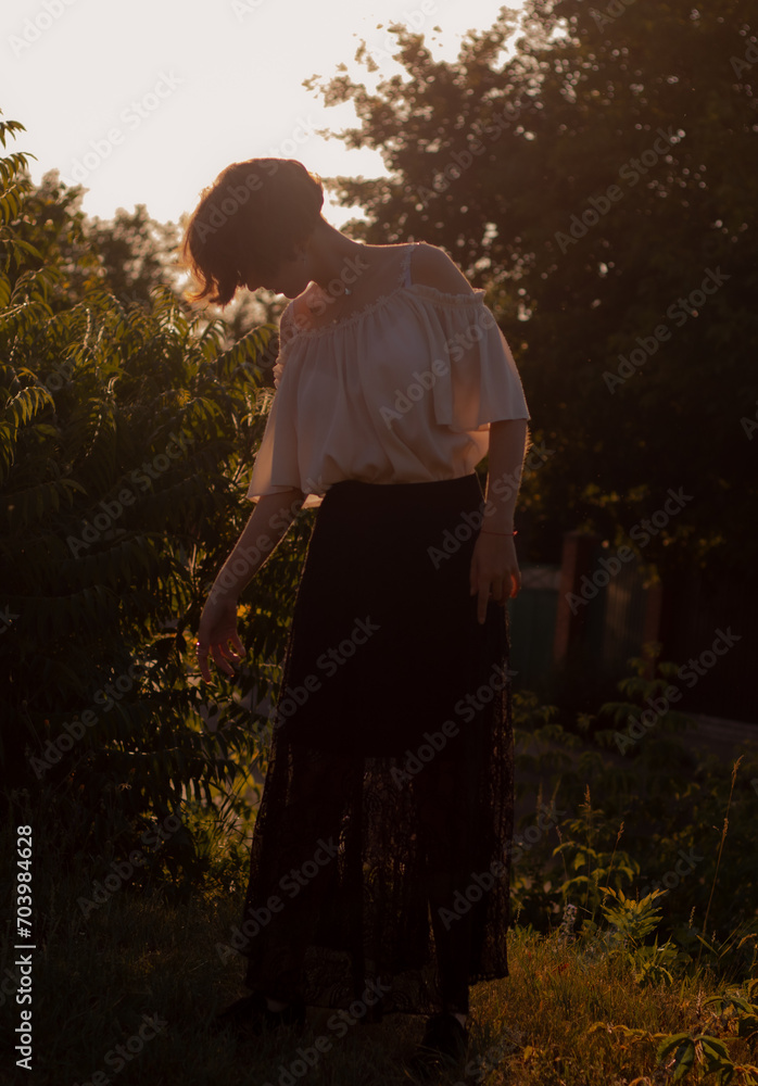 young lady walks in the garden young lady walks in the garden