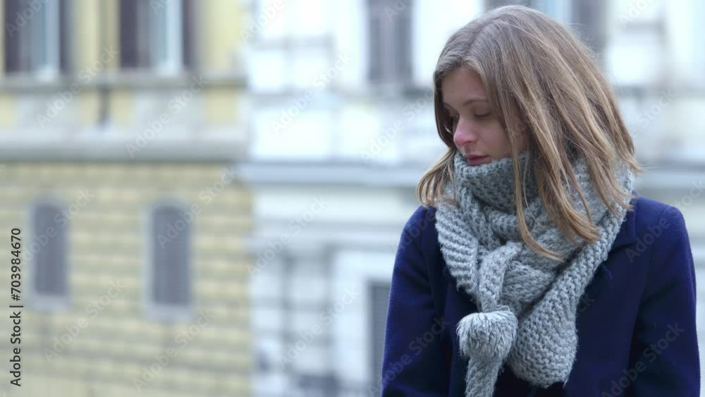 A striking young blonde woman appears pensive as she contemplates her recent life choices, looking around for inspiration A striking young blonde woman appears pensive as she contemplates her recent life choices, looking around for inspiration