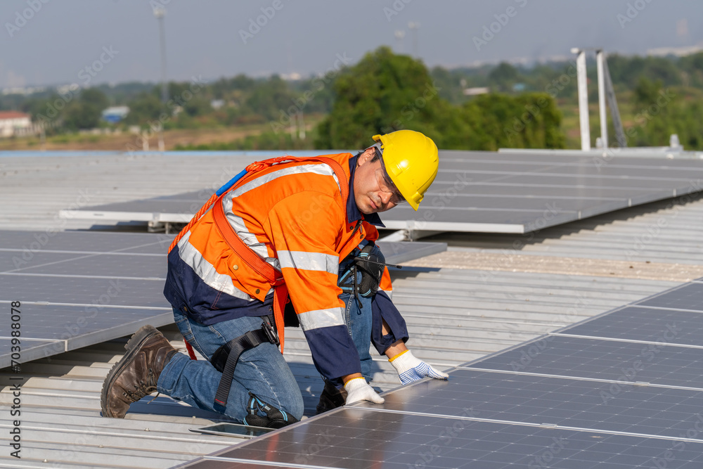 Specialist technician professional engineer checking top view of installing solar roof panel on the factory rooftop under sunlight. Engineers having service job of electrical renewable eco energy Specialist technician professional engineer checking top view of installing solar roof panel on the factory rooftop under sunlight. Engineers having service job of electrical renewable eco energy