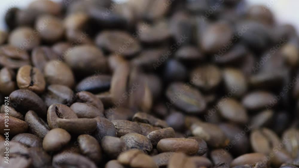 close-up of coffee beans falling into a pile.slow motion. macro coffee beans raw falling. close-up of coffee beans falling into a pile.slow motion. macro coffee beans raw falling.