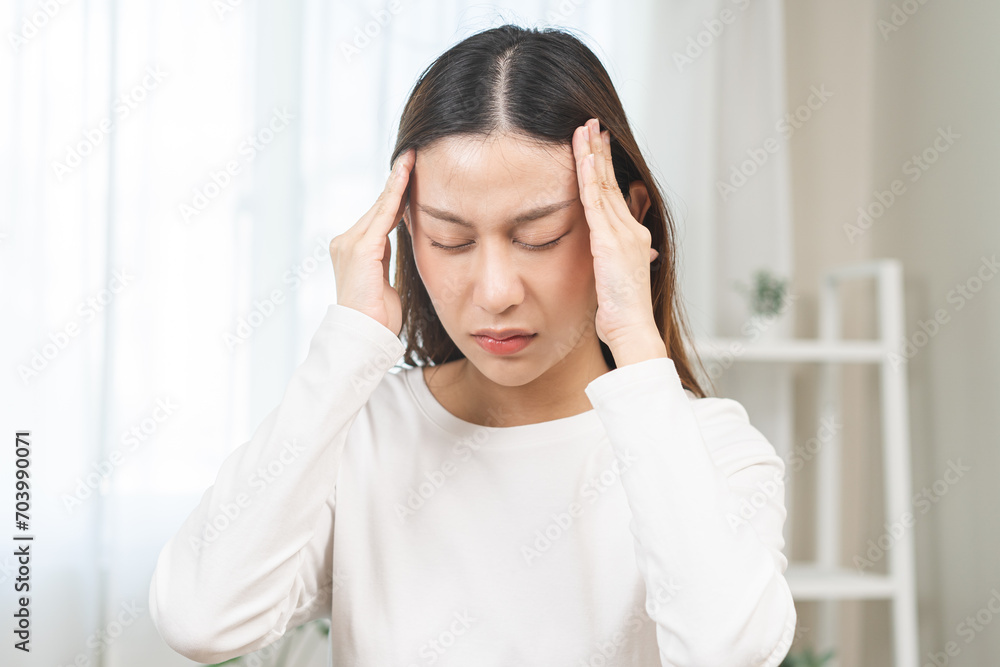 Dizzy asian young woman, girl headache or migraine pain. suffering from vertigo, difficulty standing up at home, holding head with hand, health problem of brain, inner ear not balance. Dizzy asian young woman, girl headache or migraine pain. suffering from vertigo, difficulty standing up at home, holding head with hand, health problem of brain, inner ear not balance.