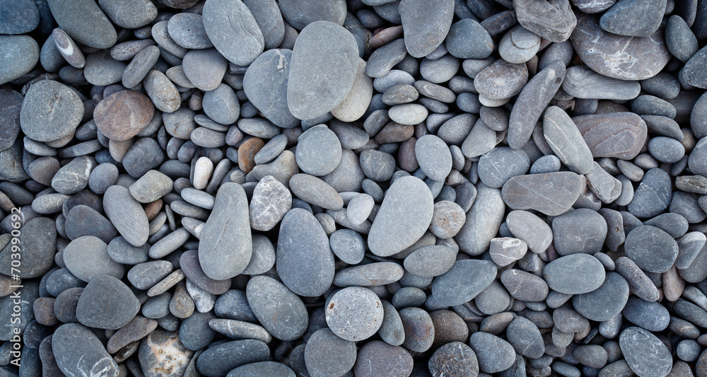 Smooth round pebbles texture background. Pebble sea beach close-up, dark wet pebble and gray dry pebble. High quality photo Smooth round pebbles texture background. Pebble sea beach close-up, dark wet pebble and gray dry pebble. High quality photo