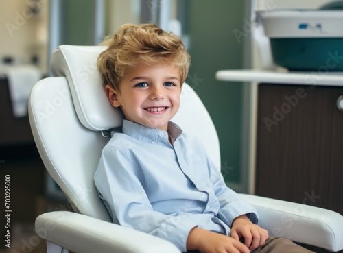 Portrait of smiling little boy sitting in dental chair at dentists office