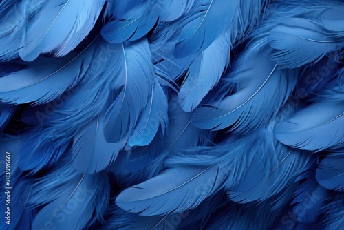  a bunch of blue feathers that are very close to each other on a blue background with a blurry image of the back of the feathers of a bird's head.