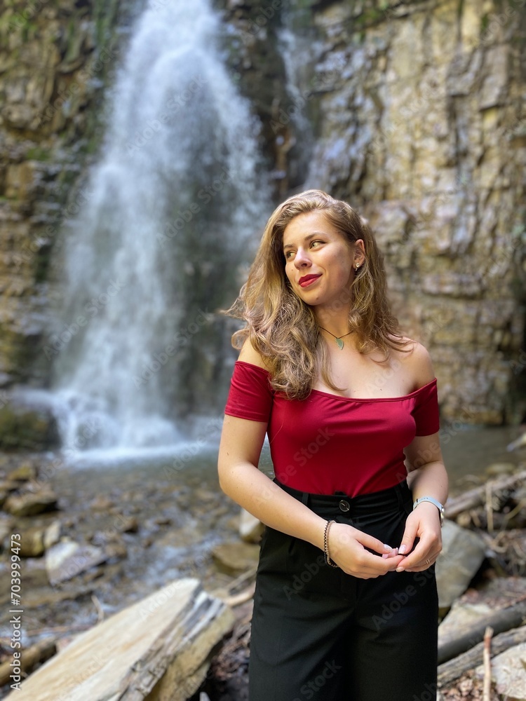 woman in front of the waterfall woman in front of the waterfall