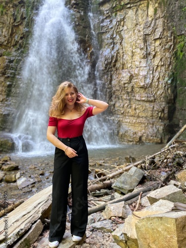 woman in the forest near the waterfall