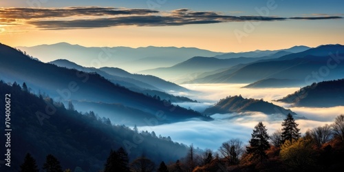 Mountain landscape with forested hills with fog in the valley at sunrise. Breathtaking natural scenery