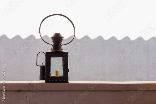 An old vintage lamp on the background of a white wall. Copy space. photo