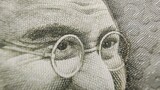 Indian rupee currency note or reserve bank of India paper money extreme macro detail close up of Mahatma Gandhi eyes. Inflation, banking, savings, investment, tax, wealth and cash concept.