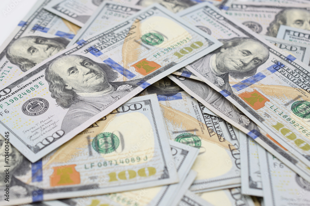 Pile of 100 dollar bills scattered in a heap. Close up view. Pile of 100 dollar bills scattered in a heap. Close up view.