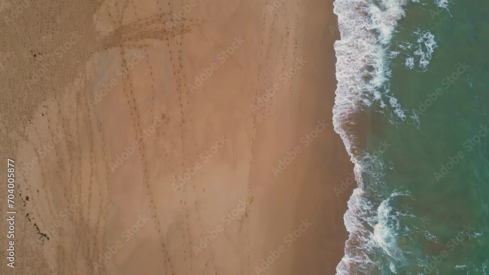 Aerial scenic ocean water washing golden sand on empty beach. Waves splashing Aerial scenic ocean water washing golden sand on empty beach. Waves splashing