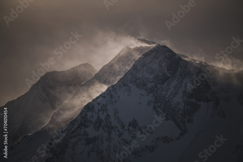strong south wind in the alps at a cloudy and sunny winter day in the national park hohe tauern in austria photo