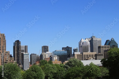 Montreal skyline in Downtown of the city, seen from Griffintown central neighborhood on a summer day. Skyscrapers and high-rise buildings in North America against blue sky.