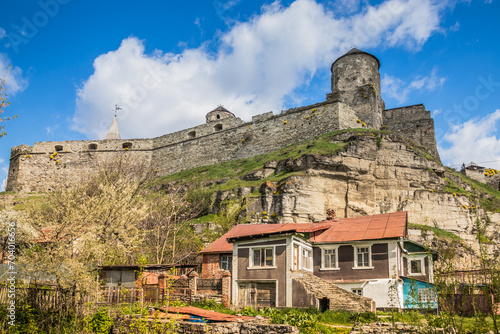 Old Kamianets-Podilskyi Castle under the blue sky. Part of the powerful bastions of the castle. The fortress located among the picturesque nature in the historic city of Kamianets-Podilskyi, Ukraine © decorator