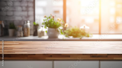 Empty wooden table top in the kitchen with kitchen utensil on the background, blurred background