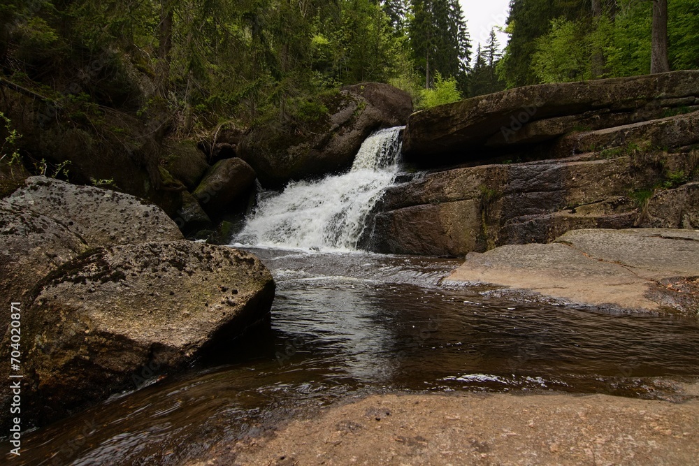 Naklejka premium waterfalls on a stream in the forest