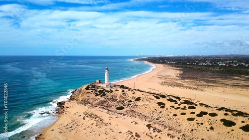 Foto Faro de Trafalgar, aerial view of the lighthouse at a sandy headland with dunes