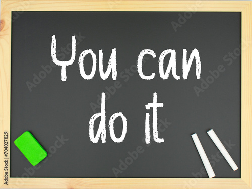 Fototapeta Naklejka Na Ścianę i Meble -  Blackboard with the words you can do it written in white with two chalks and a green eraser