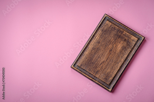 Empty wooden rectangular cutting board on a plain background, flatley with copy space photo