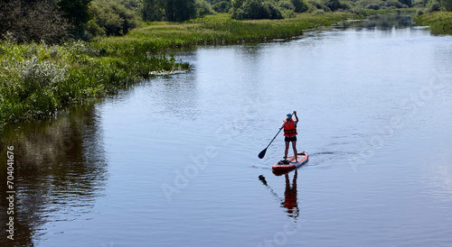 Paddleboarding on lake, aerial view. Stand up paddle boarding (SUP) water sport. photo