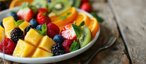 Tropical fruit salad on white plate.